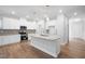 Spacious kitchen with white cabinetry, island, and stainless steel appliances at 625 Spellbrook Rd, Zebulon, NC 27597