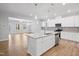 Open concept kitchen with white cabinets, granite countertops, and stainless steel appliances at 625 Spellbrook Rd, Zebulon, NC 27597