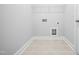 Bright laundry room with tile flooring and hookups ready for washer and dryer at 625 Spellbrook Rd, Zebulon, NC 27597