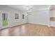 Light-filled living room features wood floors, a ceiling fan, and backyard access at 625 Spellbrook Rd, Zebulon, NC 27597