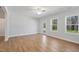 Spacious living room has wood floors, a ceiling fan, and backyard access at 625 Spellbrook Rd, Zebulon, NC 27597