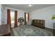 Cozy Bedroom with a modern crib, comfy glider chair, cute tree-shaped bookshelf, and two bright windows at 704 Vance St, Mebane, NC 27302