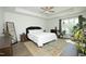 A bright main bedroom with a tray ceiling, many plants, and an oriental rug at 704 Vance St, Mebane, NC 27302