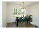 Well-lit dining room with a modern chandelier, large window, and green velvet chairs at 704 Vance St, Mebane, NC 27302