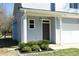 Inviting front entrance with a covered porch and craftsman-style door with sidelight at 704 Vance St, Mebane, NC 27302