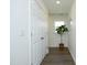 Hallway with a large closet, modern plant, and wood-look flooring, filled with natural light at 704 Vance St, Mebane, NC 27302