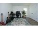 Modern home office with dual monitors, comfortable gaming chair, acoustic guitar, and bright window at 704 Vance St, Mebane, NC 27302