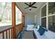 Cozy screened-in porch with comfortable seating, a ceiling fan, decorative pillows, and plenty of natural light at 704 Vance St, Mebane, NC 27302