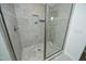 A shower room with gray tile, a glass door, and a shower head at 704 Vance St, Mebane, NC 27302
