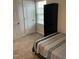 Bright bedroom featuring a bed with blue striped bedding, carpet, and a black bookshelf at 745 Little Patch St, Zebulon, NC 27597
