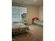 Bright bedroom featuring two twin beds, a vanity, and a window with blinds at 745 Little Patch St, Zebulon, NC 27597