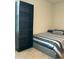 Bedroom displaying a bed with blue striped bedding and a black bookshelf for storage at 745 Little Patch St, Zebulon, NC 27597