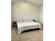 Minimalist bedroom with a comfortable bed and side tables on neutral carpet flooring at 745 Little Patch St, Zebulon, NC 27597