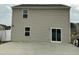 Home exterior with a concrete patio, light siding, and visible windows at 745 Little Patch St, Zebulon, NC 27597