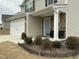 Charming two-story home features a two-car garage, stone accents, and a well-manicured front yard at 745 Little Patch St, Zebulon, NC 27597