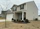 Charming two-story home features a two-car garage, stone accents, and a well-manicured front yard at 745 Little Patch St, Zebulon, NC 27597