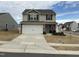 Charming two-story home features a two-car garage, stone accents, and a well-manicured front yard at 745 Little Patch St, Zebulon, NC 27597
