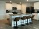 Beautiful kitchen island with granite countertop and seating, accented by stainless steel appliances at 745 Little Patch St, Zebulon, NC 27597