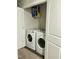 Convenient laundry room with white front-load washer and dryer and storage shelf at 745 Little Patch St, Zebulon, NC 27597