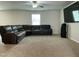 Spacious living room featuring a comfortable sectional sofa, a ceiling fan, and a large screen television at 745 Little Patch St, Zebulon, NC 27597