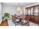 Elegant dining room with a large wooden table, china cabinet, and a stylish light fixture at 7508 Chippenham Ct, Raleigh, NC 27613