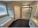 Bathroom featuring granite vanity, white cabinets, tile floor, soaking tub and glass enclosed shower at 945 Lynch Rd, Selma, NC 27576