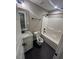 Bathroom with granite vanity, white cabinets, tile floor, and white tub and shower at 945 Lynch Rd, Selma, NC 27576