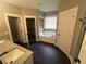 Bathroom featuring granite vanity, white cabinets, tile floor, soaking tub, window, and storage closet at 945 Lynch Rd, Selma, NC 27576