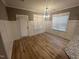 Elegant dining room features modern chandelier lighting, windows, and wainscoting at 945 Lynch Rd, Selma, NC 27576