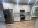 Modern kitchen features stainless steel appliances, granite counters, and white cabinetry at 945 Lynch Rd, Selma, NC 27576