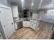 Open kitchen with granite countertops, stainless appliances, and hardwood floors at 945 Lynch Rd, Selma, NC 27576