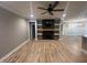 Spacious living room features wood flooring, a fireplace, and built-in shelves at 945 Lynch Rd, Selma, NC 27576