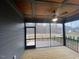 Relaxing screened porch featuring a ceiling fan and an outdoor view at 945 Lynch Rd, Selma, NC 27576