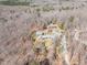 Expansive aerial view of a home nestled in a wooded area, showcasing its secluded and natural setting at 95 Blueberry Rdg, Pittsboro, NC 27312