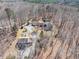 Aerial shot showcasing the property's layout amidst a dense forest and long driveway at 95 Blueberry Rdg, Pittsboro, NC 27312