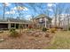 Spacious backyard featuring beautiful landscaping and a partially obscured hot tub on wooden deck at 95 Blueberry Rdg, Pittsboro, NC 27312