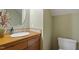 Powder room featuring a wood vanity, decorative mirror, floral arrangement, and modern sink at 95 Blueberry Rdg, Pittsboro, NC 27312
