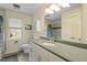 Clean bathroom featuring a white vanity with granite countertop, shower-tub combo, and ample lighting at 95 Blueberry Rdg, Pittsboro, NC 27312