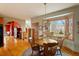 Dining area adjacent to kitchen features hardwood floors, wood trim, table and four chairs at 95 Blueberry Rdg, Pittsboro, NC 27312