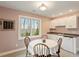 Charming dining area with a round table set and built in cabinets and wet bar at 95 Blueberry Rdg, Pittsboro, NC 27312