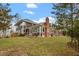 Exterior view of the home showing large windows and an attractive outdoor space at 95 Blueberry Rdg, Pittsboro, NC 27312