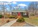 Charming home features a welcoming red door and cozy front porch with landscaped walkway at 95 Blueberry Rdg, Pittsboro, NC 27312