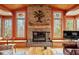 The living room with a stone fireplace, flanked by decorative windows at 95 Blueberry Rdg, Pittsboro, NC 27312