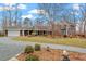 Stunning exterior view of home with a long driveway and beautiful landscaping, perfect for serene living at 95 Blueberry Rdg, Pittsboro, NC 27312