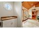 Hallway featuring tile floors, vanity sink and large windows that lead to the sunroom at 95 Blueberry Rdg, Pittsboro, NC 27312