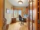 Bright home office featuring wood floors, built-in cabinets, a desk, and a large window with a scenic view at 95 Blueberry Rdg, Pittsboro, NC 27312