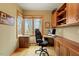 Cozy home office boasts natural light with built-in wooden cabinets, drawers, and desk for productivity at 95 Blueberry Rdg, Pittsboro, NC 27312