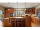 Kitchen featuring hardwood floors, wooden cabinets, granite counters and island with bar seating at 95 Blueberry Rdg, Pittsboro, NC 27312