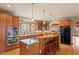 Bright kitchen featuring wood cabinets, granite counters, stainless appliances, and island with bar seating at 95 Blueberry Rdg, Pittsboro, NC 27312