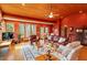 Spacious living room with wood ceiling, floors, a stone fireplace, and an open floor plan at 95 Blueberry Rdg, Pittsboro, NC 27312